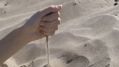 Pours it sand from hands Stock Footage 78770256