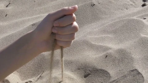 Pours it sand from hands Stock Footage 78770367