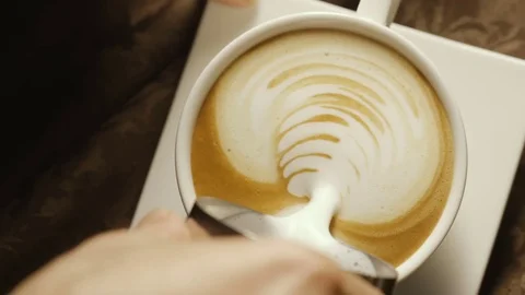 Pours milk into a coffee cup in a cafe Video stock 80334957