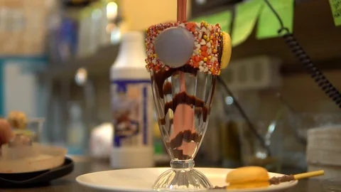Pours a milkshake in a glass 스톡 동영상 86066182