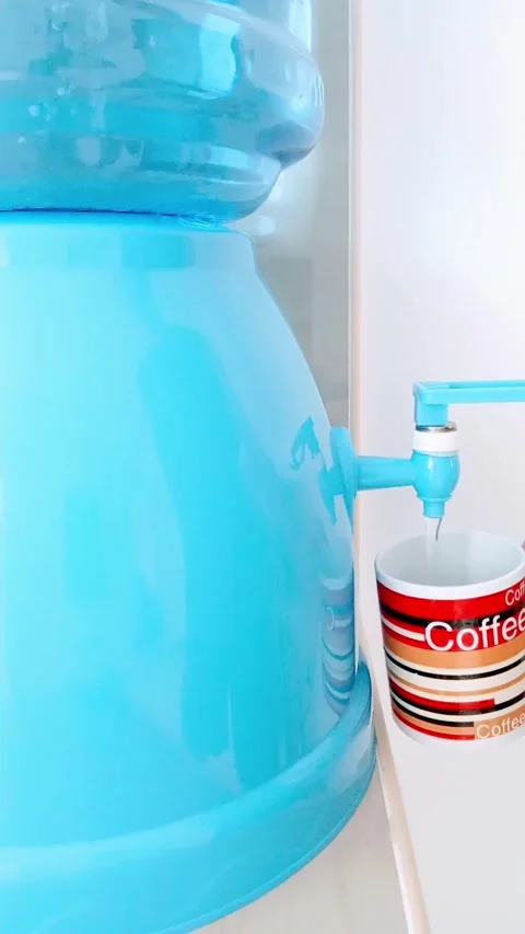 Pours water from a cooler into a cup Stock Footage 322166286