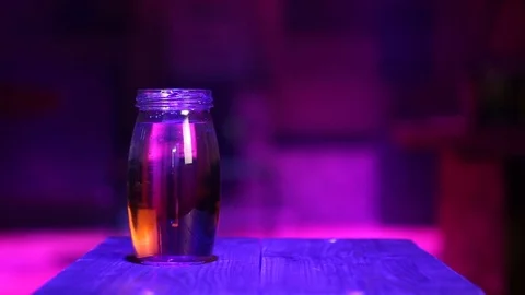 Pours water into the jar Stock Footage 99932616