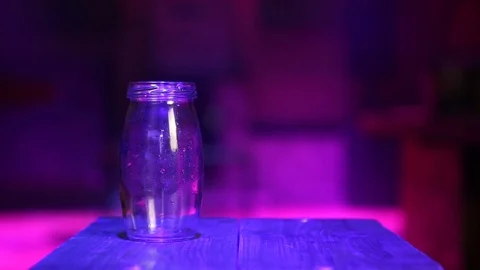 Pours water into a round jar Stock Footage 99932620