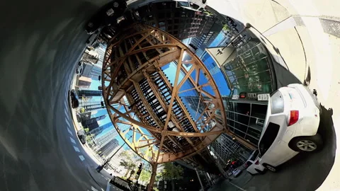 POV 360 degree tiny planet view of driving under Chicago elevated trai Stock Footage 325691670