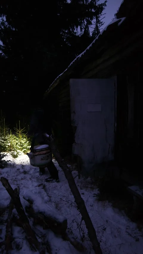 POV Action: Man Running Out of Remote Log Cabin into Snowy Winter Forest Stock Footage 333901784