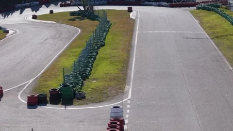 POV aerial drone tracking of an empty go-kart track with twists and turns Stock Footage 298259697