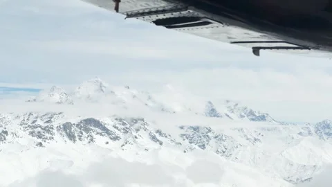 POV airplane window aerial view over Tetnuldi Peak during domestic flight a.. Stock Footage 342785920