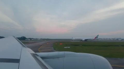 POV Airplane Window View of Emirates Plane on Runway at KLIA 스톡 동영상 346667318