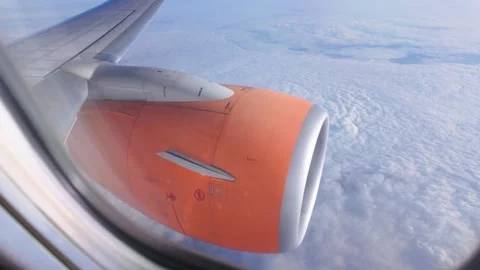 POV Airplane Window View Pulling Back from Jet Engine to Passenger Seat Stock Footage 345859600