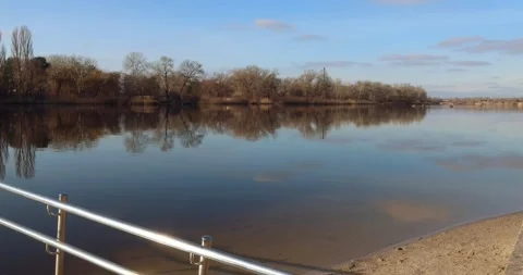 POV approaching river edge from dock with staircase handrails in view. 库存影片 300364029