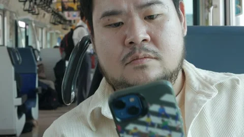 POV of an asian man using mobilephone smartphone while sitting on train com.. Stock Footage 320448531