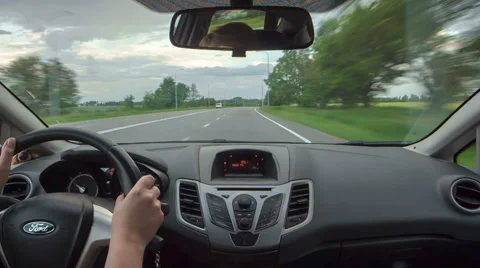 POV back sit view, driving car on road out of city, green fields, highway Stock Footage 67140786