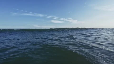 POV of bather tracking ocean waves rolling in from horizon to shore golden Stock-Footage 333471482