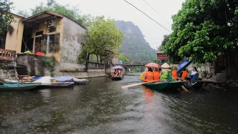 POV from boat floating on river passing by other tourists in ninh binh province Stock Footage 147353277