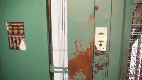 POV calling on the elevator in an old worn down building Stock Footage 168815332