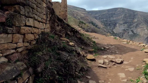 POV of camera flying in stone ruins of ancient ghost town Gamsutl, Dagestan Stock Footage 196164539