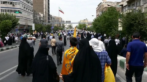 POV camera moves behind crowd of people demonstrating in Iran during Quds day Video stock 70878773