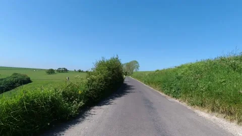 POV Car drive down a Scenic, green, english countryside on a sunny day Stock Footage 155403603