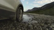 Pov, Car Driving Across Mountain River, Tire Riding On Gravel Road Stock Footage