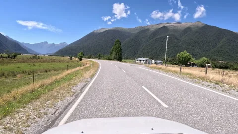 POV of car driving down a mountain road - New Zealand roadtrip Stock Footage 235715603