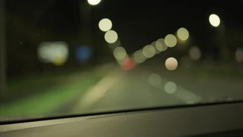 POV of car driving at night time with blurred bokeh Stock Footage 264131570