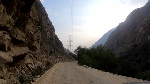 POV in the car driving seeing high voltage antennas with cables between bushes o 库存影片 198798545