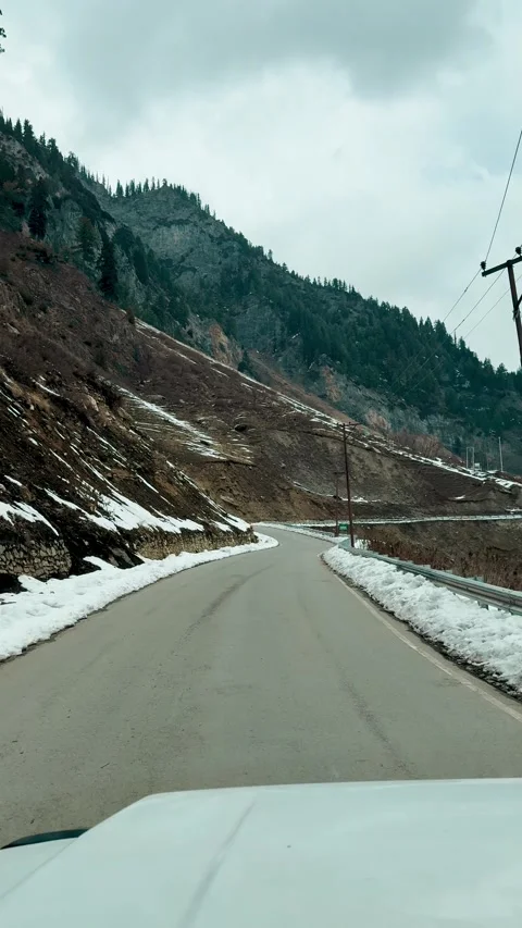 POV car driving through winter road in Kashmir, India. Snow covering the roadsid Stock Footage 340573998