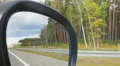 POV of car passenger, roadside landscape reflected in side view mirror, driving HD Footage