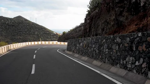 Pov of a car riding down a winding road in Tenerife, Spain Stock Footage 112288830
