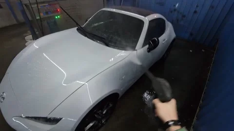 POV car wash of Mazda MX5 sport car with pressure washer Stock Footage 295841453