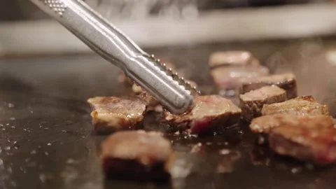 POV Chef Cooking Premium Kobe Wagyu Beef Steak on Teppanyaki Iron Pan Stock Footage 337441048