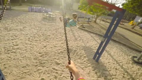 POv of child on a swing in a playground Video stock 77969714
