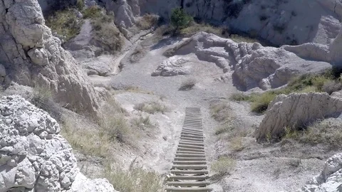 POV climbing down a rope ladder in the Badlands Stock Footage 81765028
