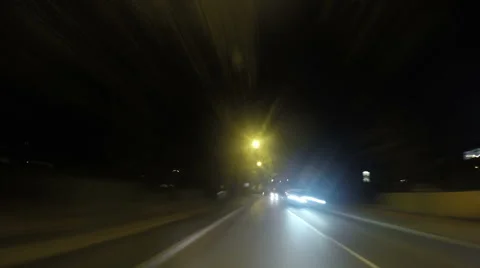POV clip speeding down busy streets at night Stock Footage 43378742