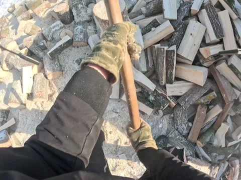 POV close up of chopping firewood with an axe in winter outdoors Stock Footage 329366149