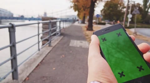 POV: Close-up of Male Hand using Smartphone in the City. Chromakey. 4K. 스톡 동영상 67223373