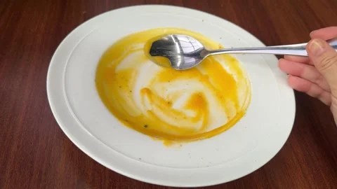 POV Close Up Spooning Last Bites of Creamy Pumpkin Soup from Plate Description 스톡 동영상 335500707