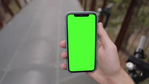 POV Close-up young man watching on iPhone 11 green mock-up blank screen browsing Stock Footage 139092586