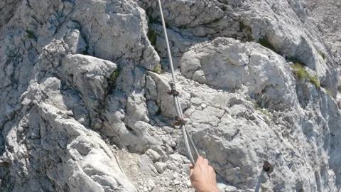 POV closeup of hiker with hands getting grip in Via ferrata alpine climb Stock Footage 161518537