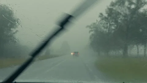 POV Closeup Windshield Wipers in Heavy Rain with Oncoming Traffic and Stock Footage 337438758