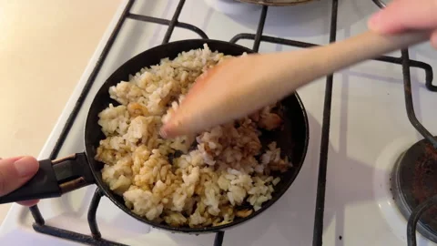 POV cooking fried rice with meat. frying pan on gas stove at home. Delicious Stock Footage 280209886