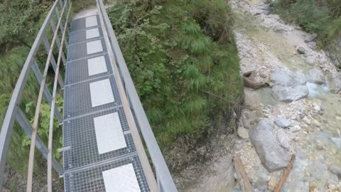 POV crossing bridge over river stream looking down - hiking/trekking Stock Footage 160906283