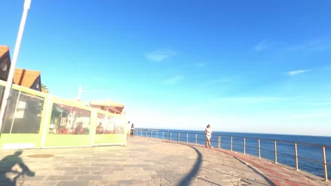 POV of cyclist on the boardwalk between Cascais and Estoril, Portugal on a sunny Stock Footage 138945004