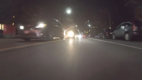 POV dark low angle drive at night on city of Toronto streets Video stock 99407714