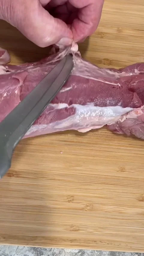 POV Demonstration Removing Silver Skin from Pork Tenderloin Close Up 4K Vertical Stock Footage 337797166