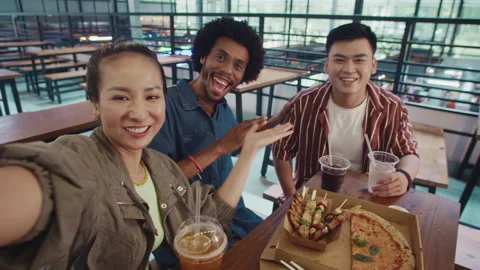 POV of Diverse People Vlogging while Eating Pizza with Drinks in Cafe Stock Footage 266965532