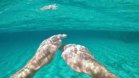 POV: Diving alone in the breathtaking turquoise ocean on a sunny day in summer. Stock Footage 94653603