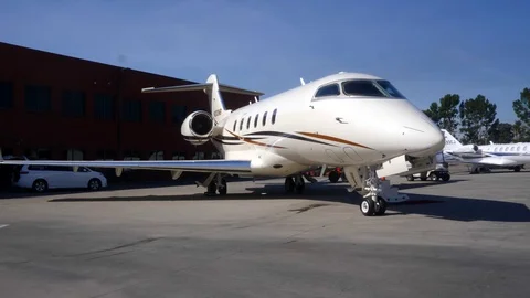 POV DOLLY INTO BUSINESS JET ON TARMAC AT AIRPORT Stock Footage 97522453