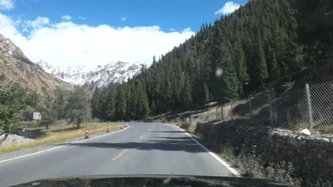 POV drive on Duku Highway through snowy Tianshan Mountains Stock Footage 340216847