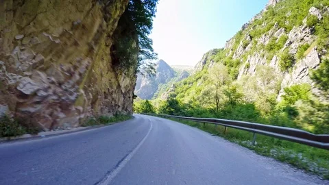 POV drive narrow canyon dramatic nature rocks curvy road sunny day car travel Stock Footage 90812401